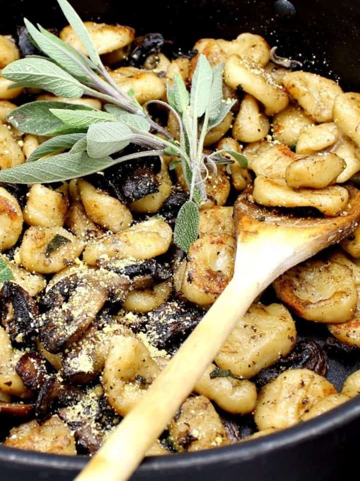 Vegan Sage Butter Gnocchi pasta in a pan with wooden spoon