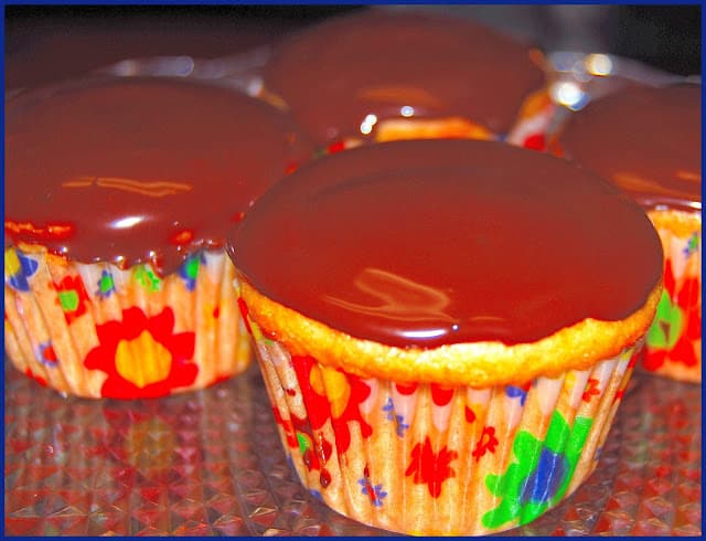 Photo of vegan vanilla cupcakes with chocolate ganache frosting.