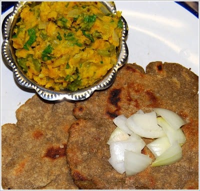 Photo of zunka, a stir-fry of vegetables with chickpea flour, and bhakar, a millet flatbread.
