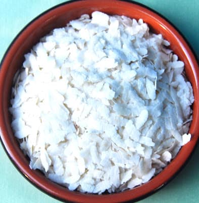 Photo of aval or poha, flattened rice flakes, in an earthen bowl