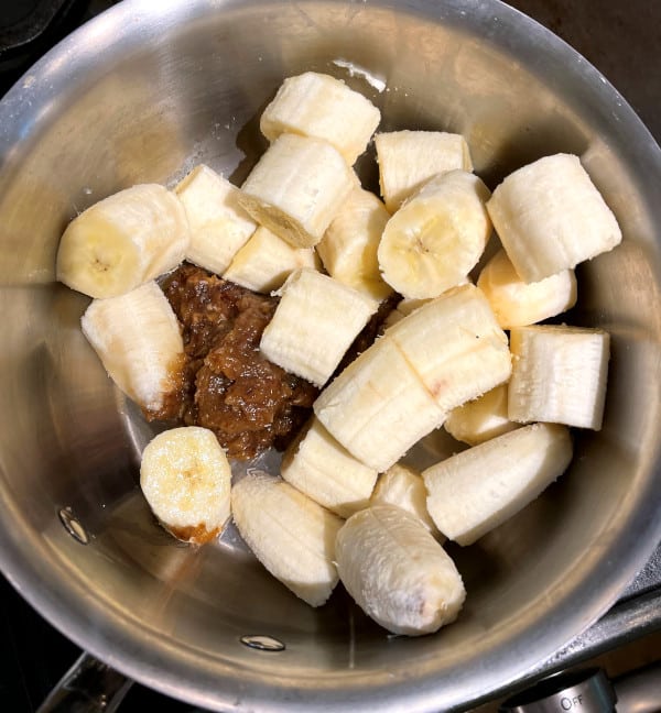 Banana and blended dates in saucepan.