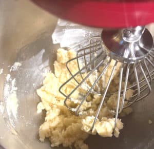 Stand mixer mixing butter and sugar in stand mixer.