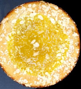 Vegan lemon cake with sliced almonds on top.