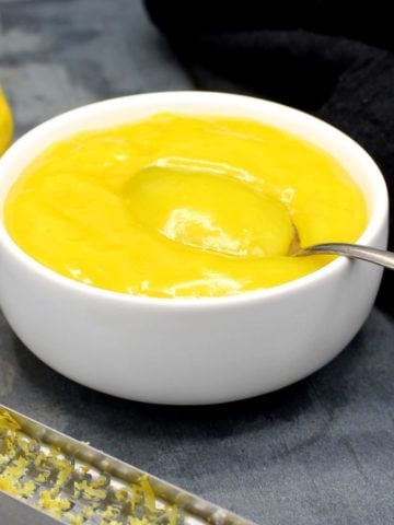 A bowl of vegan lemon curd with spoon.