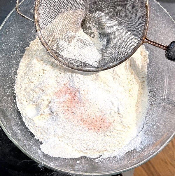 Flour being sifted into bowl.