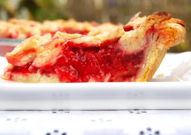 Slice of vegan strawberry pie with a flaky crust.