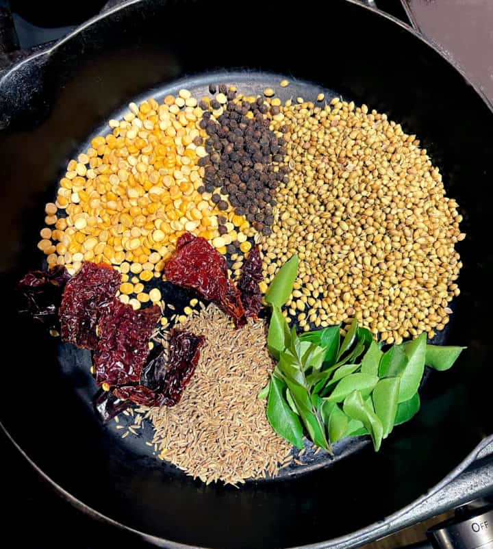 Ingredients for curry powder in cast iron skillet.