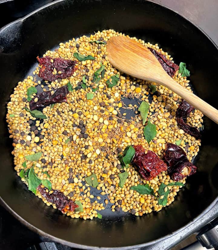 Spices roasting in cast iron pan for curry powder.