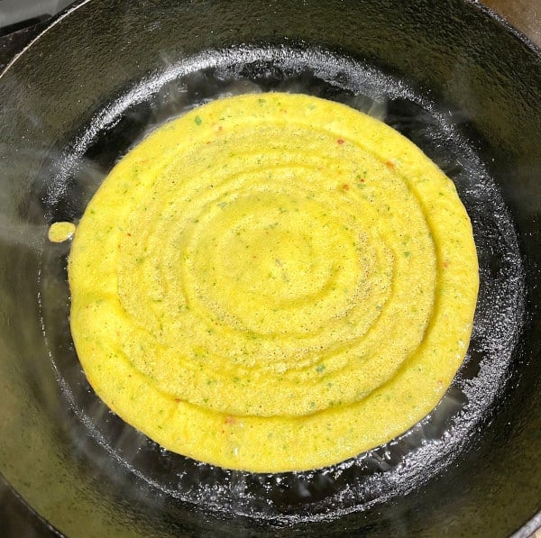 Adai cooking on a cast iron skillet
