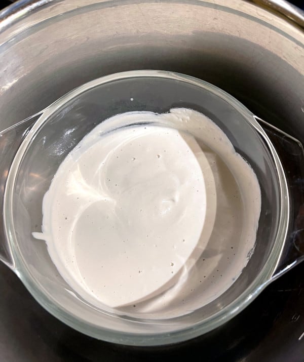 Cashew cream in pyrex bowl inside Instant Pot inner pot or liner.