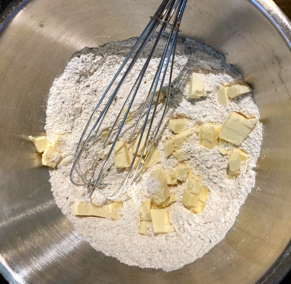 Butter in flour in bowl with whisk.