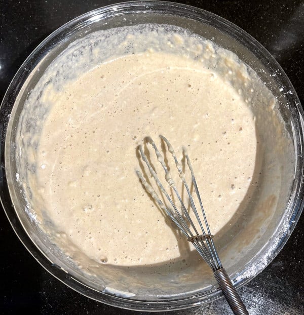 Batter for vegan sheet pan pancakes in a bowl with whisk.