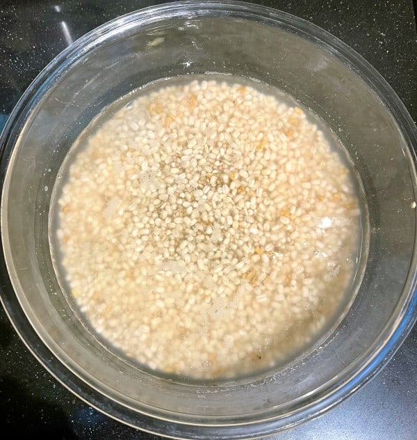 Sorghum dosa ingredients after soaking in glass bowl