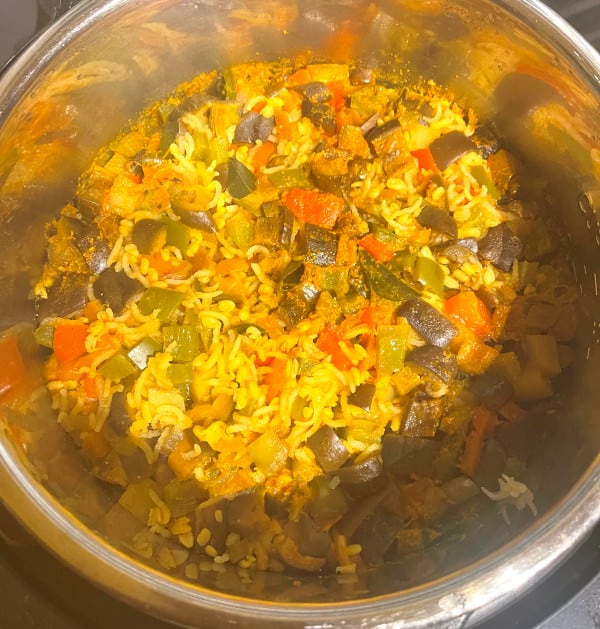 Cooked masala khichdi with steam rising in Instant Pot