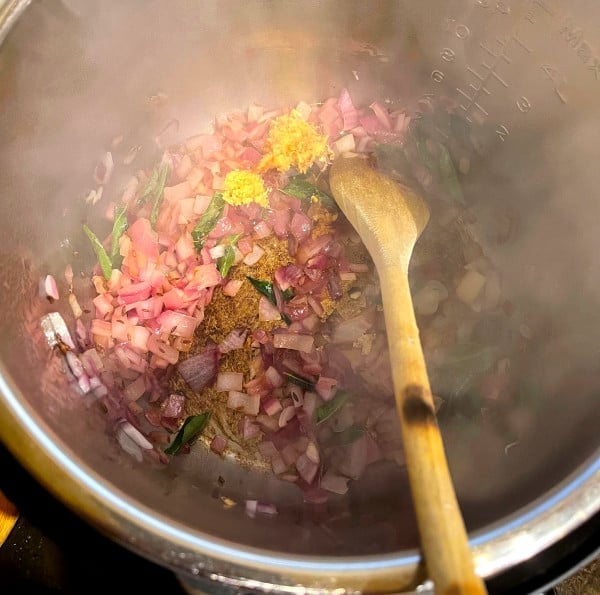 Onions, curry leaves and cumin in Instant Pot for khichdi