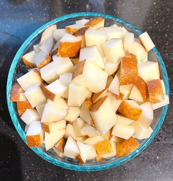 Diced potatoes in glass bowl.