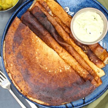 Quinoa dosa arranged on a serving plate with coconut chutney.