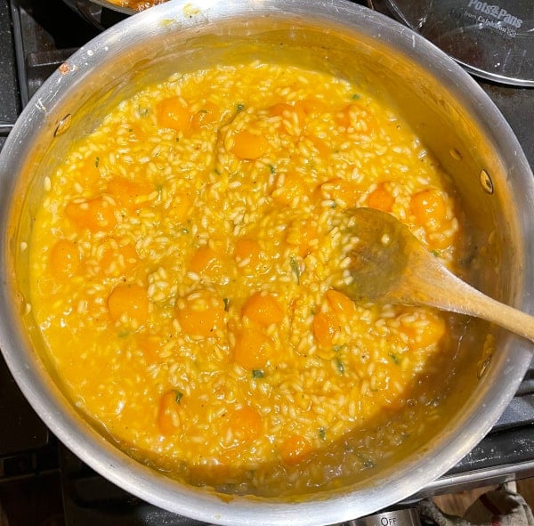 Stock added to risotto rice and butternut squash