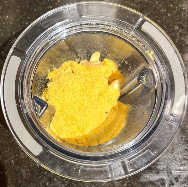 Cashews and nutritional yeast in blender jar