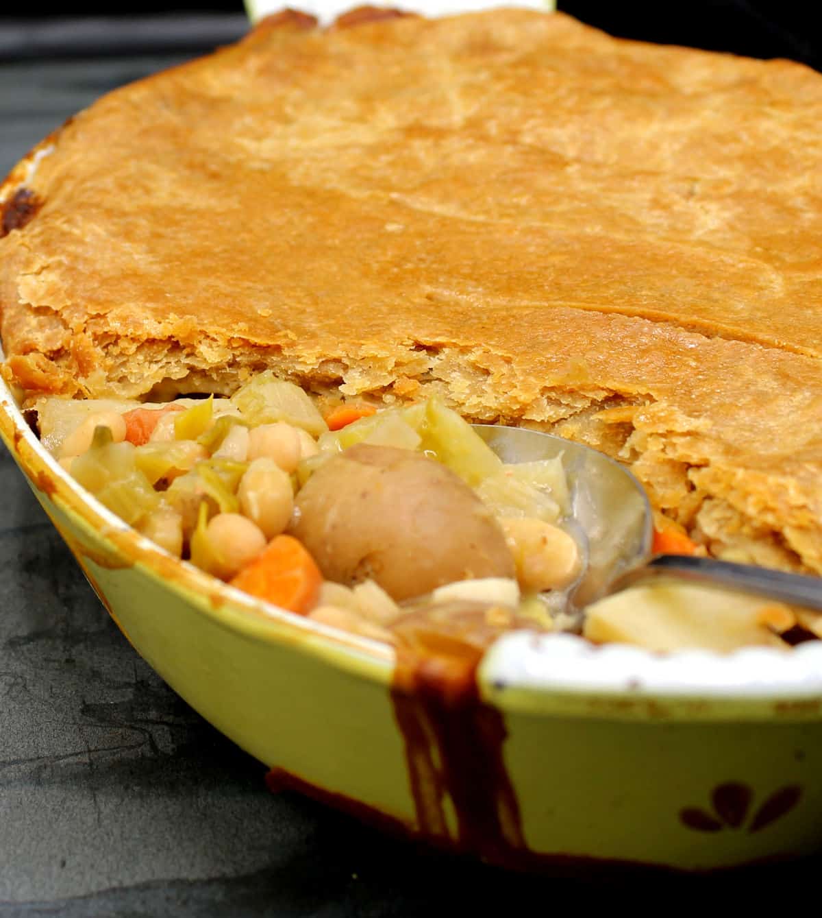 Closeup of a pot pie with a flaky whole wheat puff pastry crust.