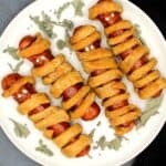 Four vegan mummy dogs on a plate
