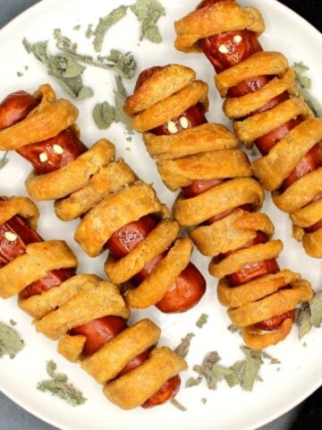 Four vegan mummy dogs on a plate