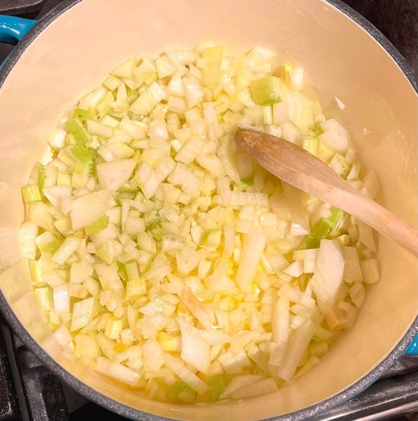Onions and celery with garlic in large pot
