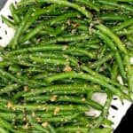 Closeup of garlic green beans with garlic, sesame seeds and red pepper flakes