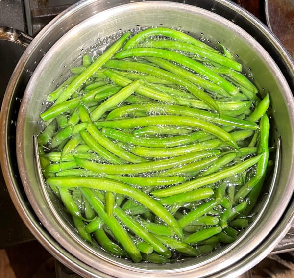 Green beans in boiling water for blanching