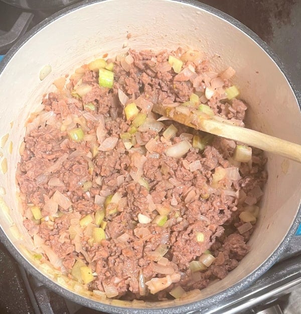 Vegan beef added to celery, onions and garlic for chili.