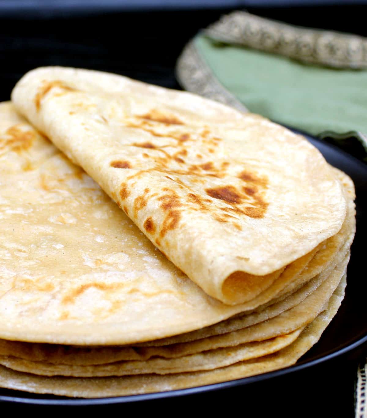 Front photo of freshly made rotis on a plate.