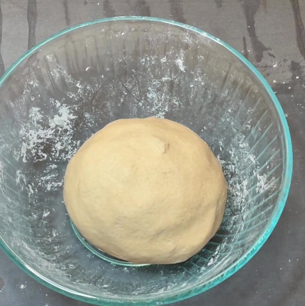 Kneaded dough ball in bowl.