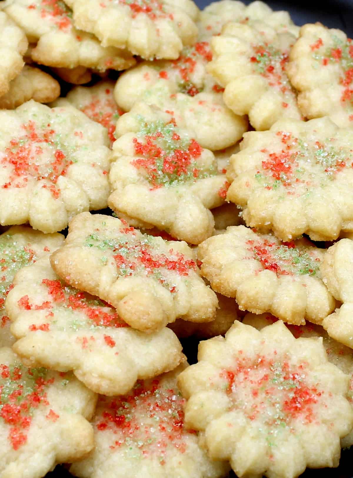 Vegan spritz cookies with colored sugar sprinkles.