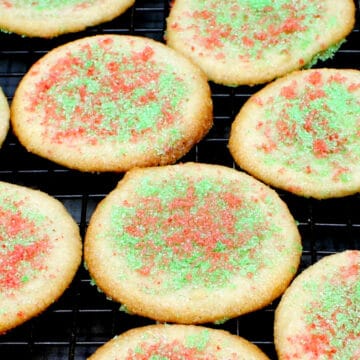 Buttery vegan almond cookies with a topping of colored sugar.