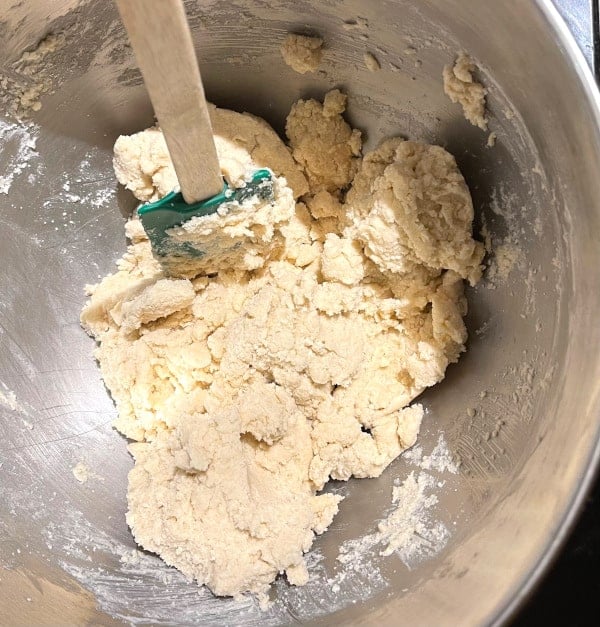 Cookie dough in bowl with spatula.