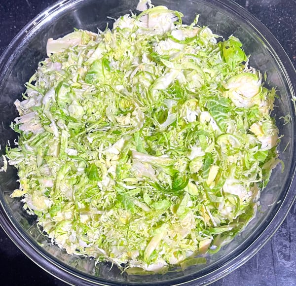 Sliced or shaved brussels sprouts in glass bowl,
