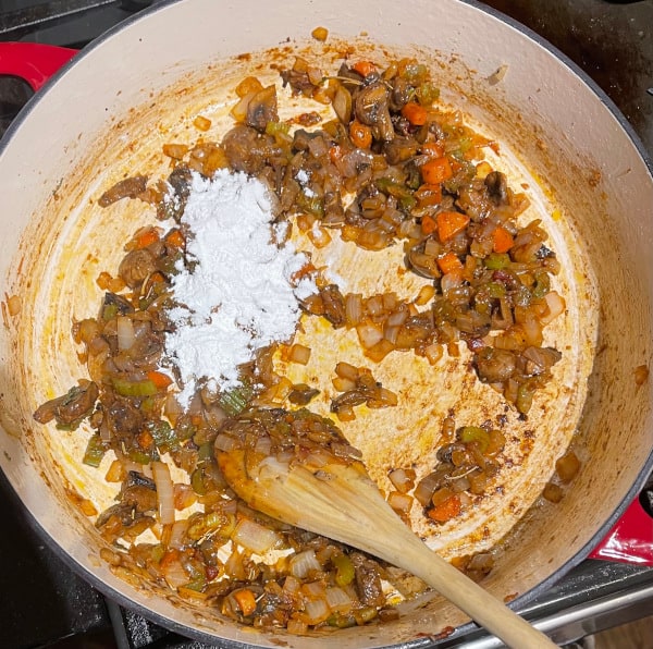 Tapioca starch added to skillet as thickener for vegan gravy.