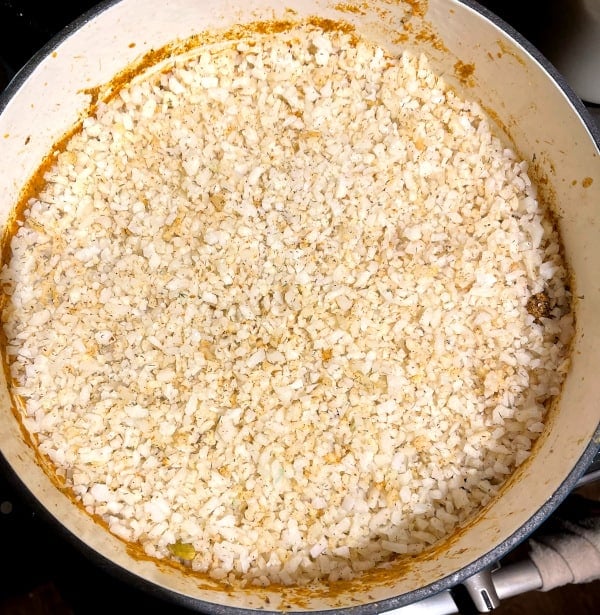 Cauliflower rice layered over biryani gravy.