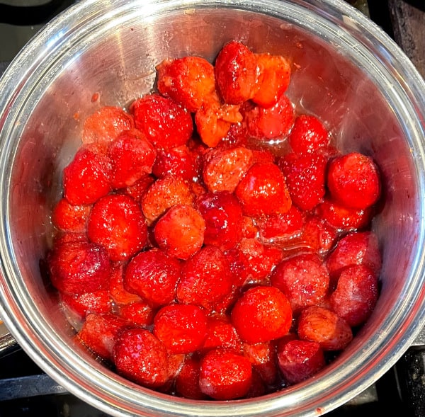 Strawberries in saucepan for topping.