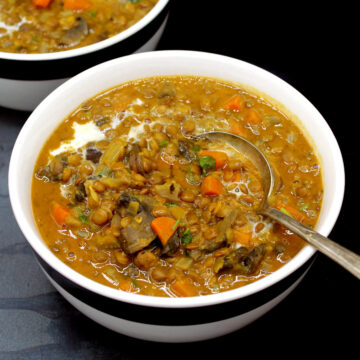 Bowls of lentil soup with spoon.