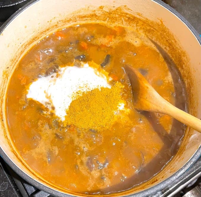 Curry powder and coconut milk added to lentil soup.