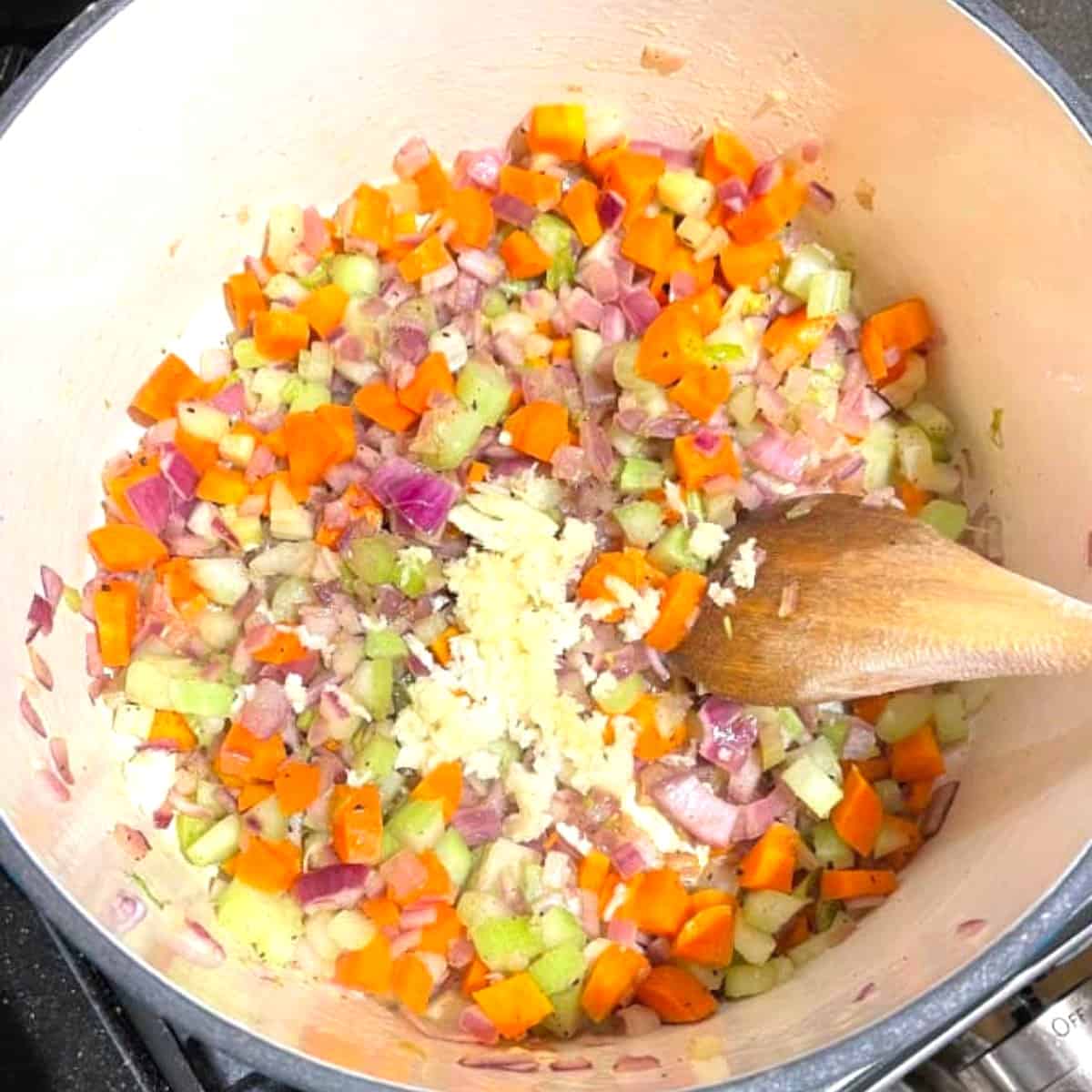 Garlic added to veggies in pot for lentil soup.