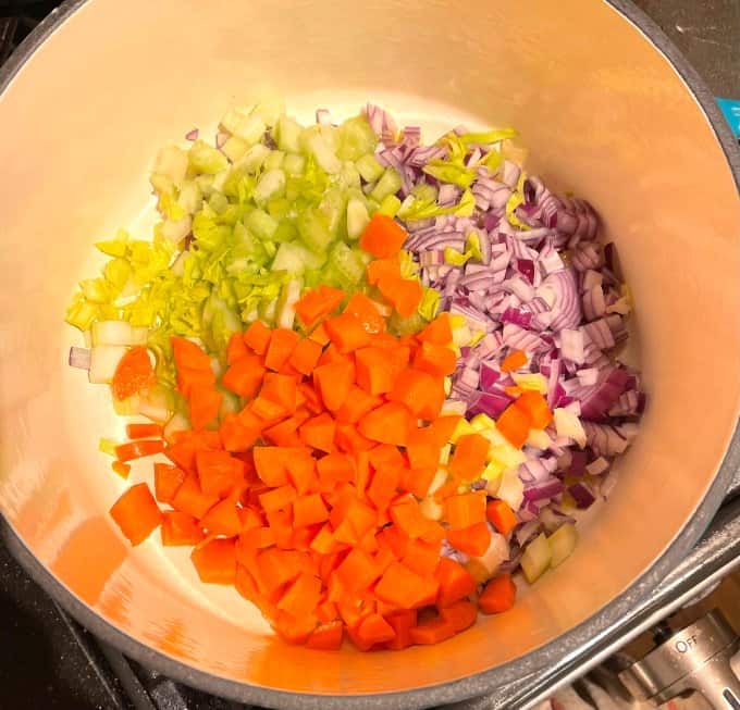 Celery, carrots and onions in pot.