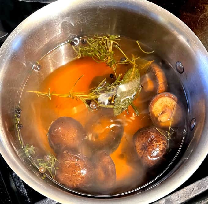 Cooked mushroom stock in saucepan.