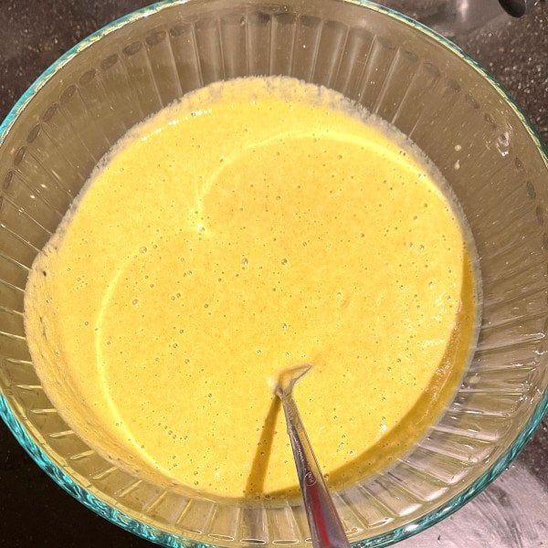 Moong chilla batter ground into a smooth paste in bowl.