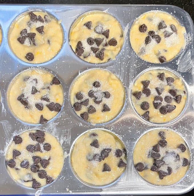 Muffin batter in muffin tin cups.