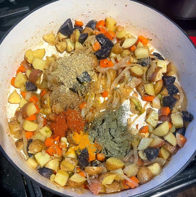 Indian spices and mint stirred into veggies for casserole.
