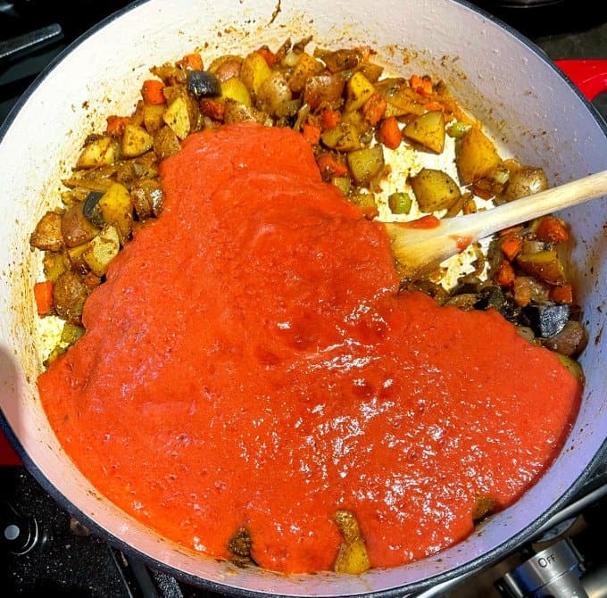Tomato puree added to skillet.