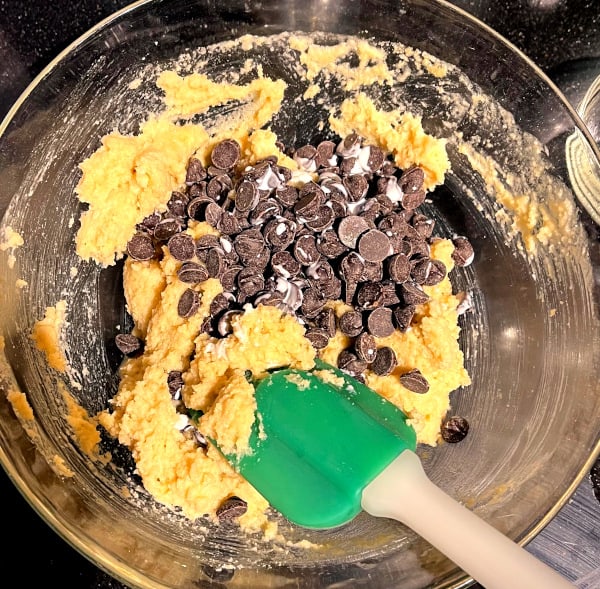Keto chocolate chips added to cookie batter.