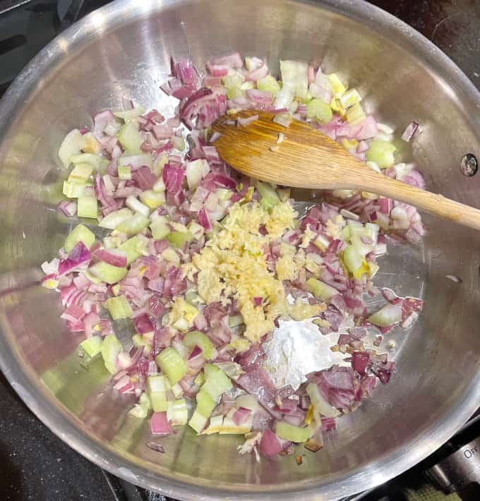 Garlic stirred into celery and onions in skillet.